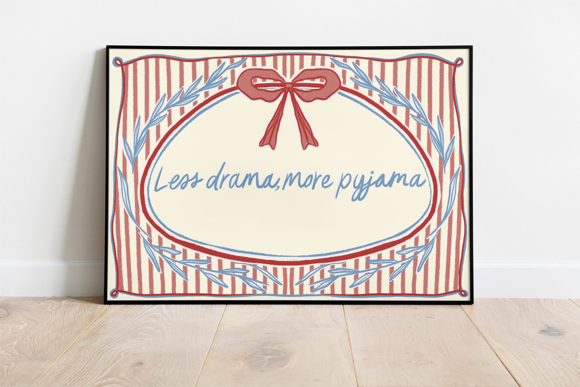 landscape orientation print with a beige background, pink stripes and a pink bow with red outline in the top middle. blue outlines of leave form an oval in the center and the quote reads in blue hand writing "less drama more pyjama"