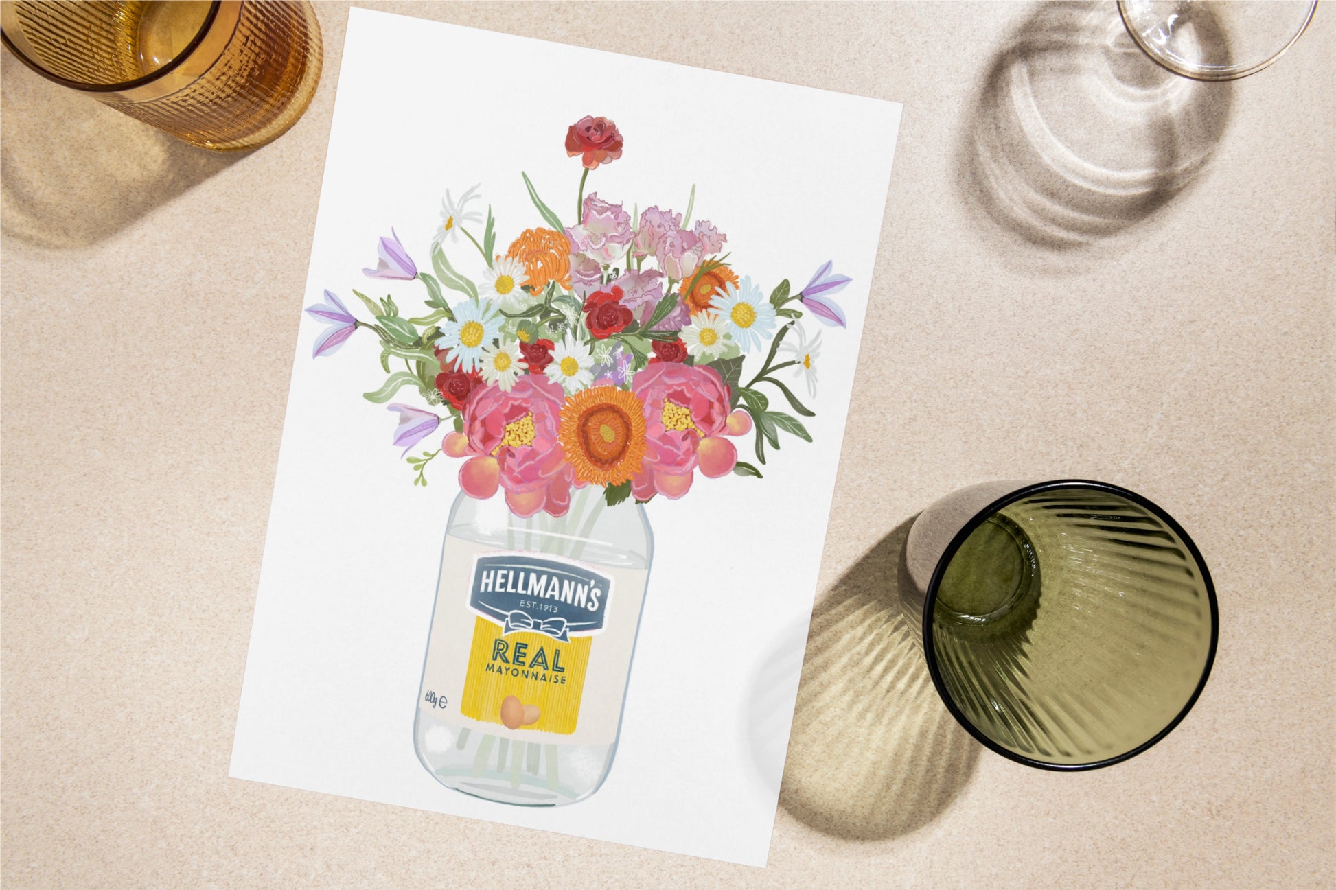 Floral arrangement in a Hellmann's mayonnaise jar on a table with glasses.
