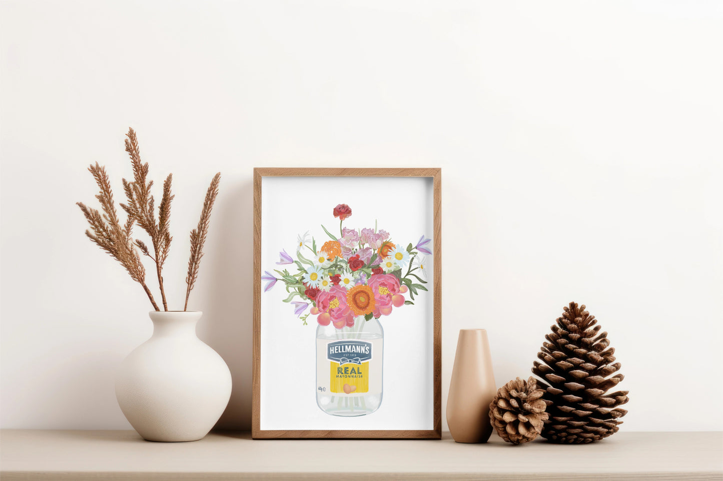 Framed artwork of a floral design on a shelf with decorative items.