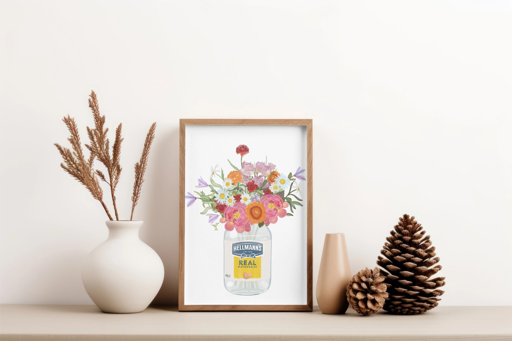 Framed artwork of a floral design on a shelf with decorative items.