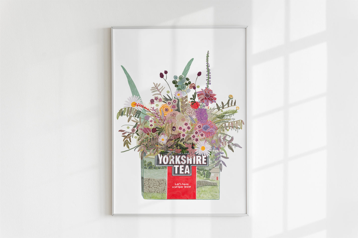 An illustrated yorkshire tea box with pretty illustrative pastel toned florals and foliage blooming from the box on a white background