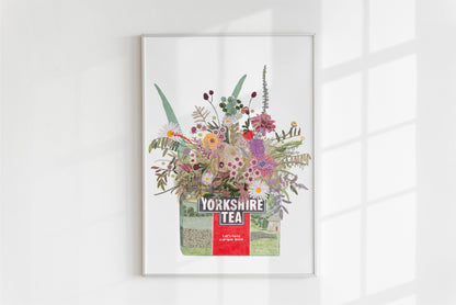 An illustrated yorkshire tea box with pretty illustrative pastel toned florals and foliage blooming from the box on a white background